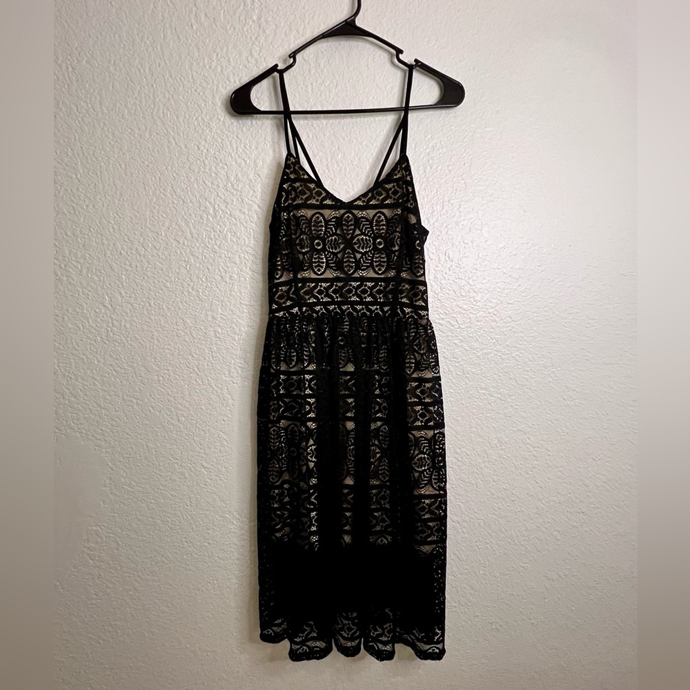 Tea length black lace dress W/beige lining and adjustable straps.